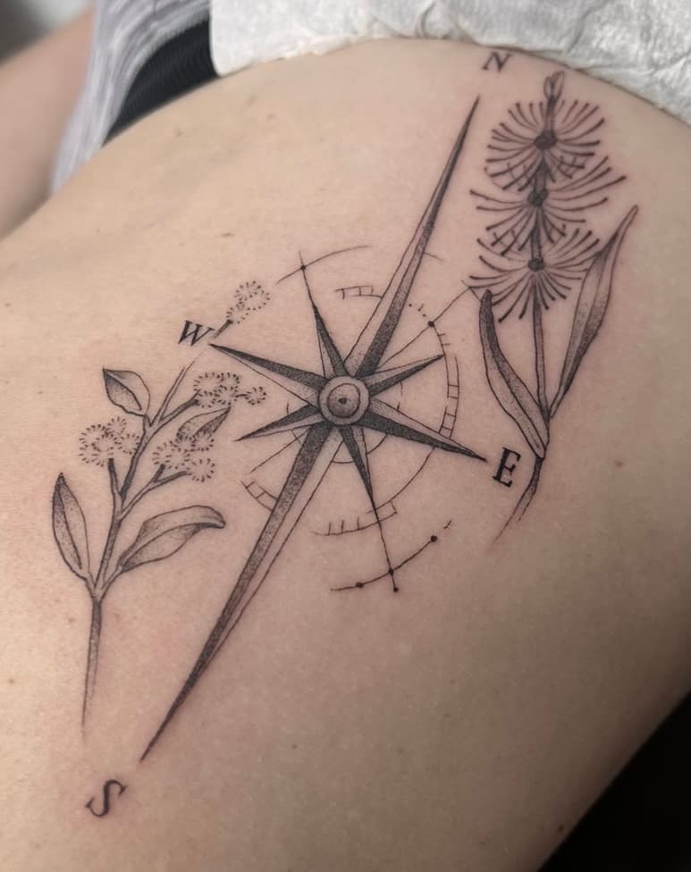 Fine line compass and botanical tattoo by Independence Ink.